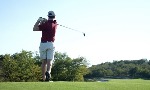 A man playing golf in the field